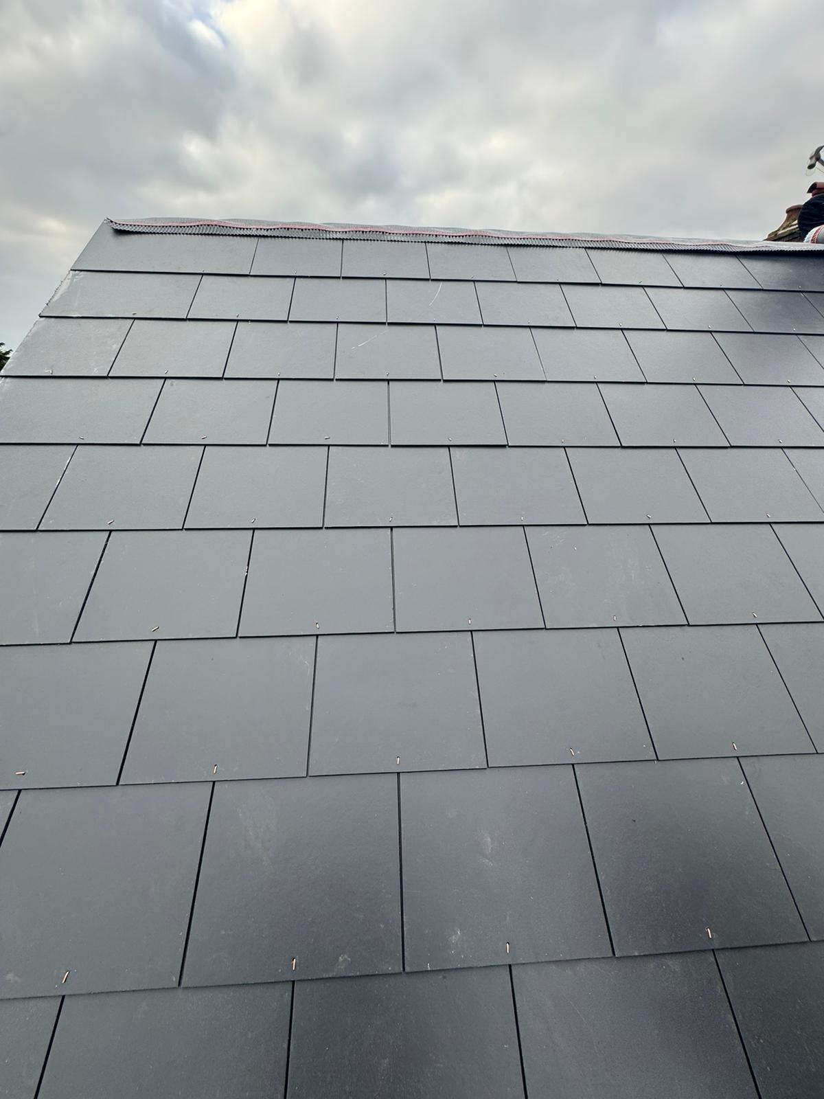 New natural blue slate roof laid to precise gauge with copper nails