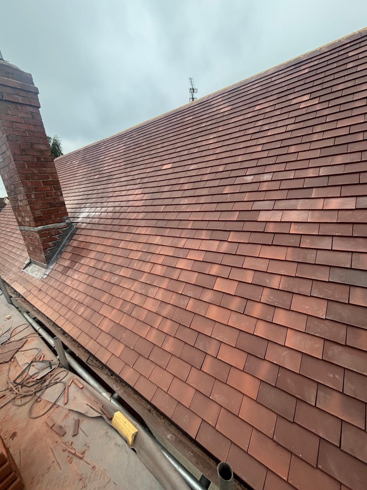 New clay plain tile roof with chimney and fresh lead soakers