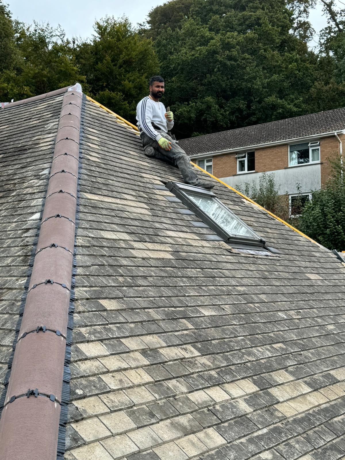Alpha Roofcare craftsman on a re-roof with a new Velux skylight