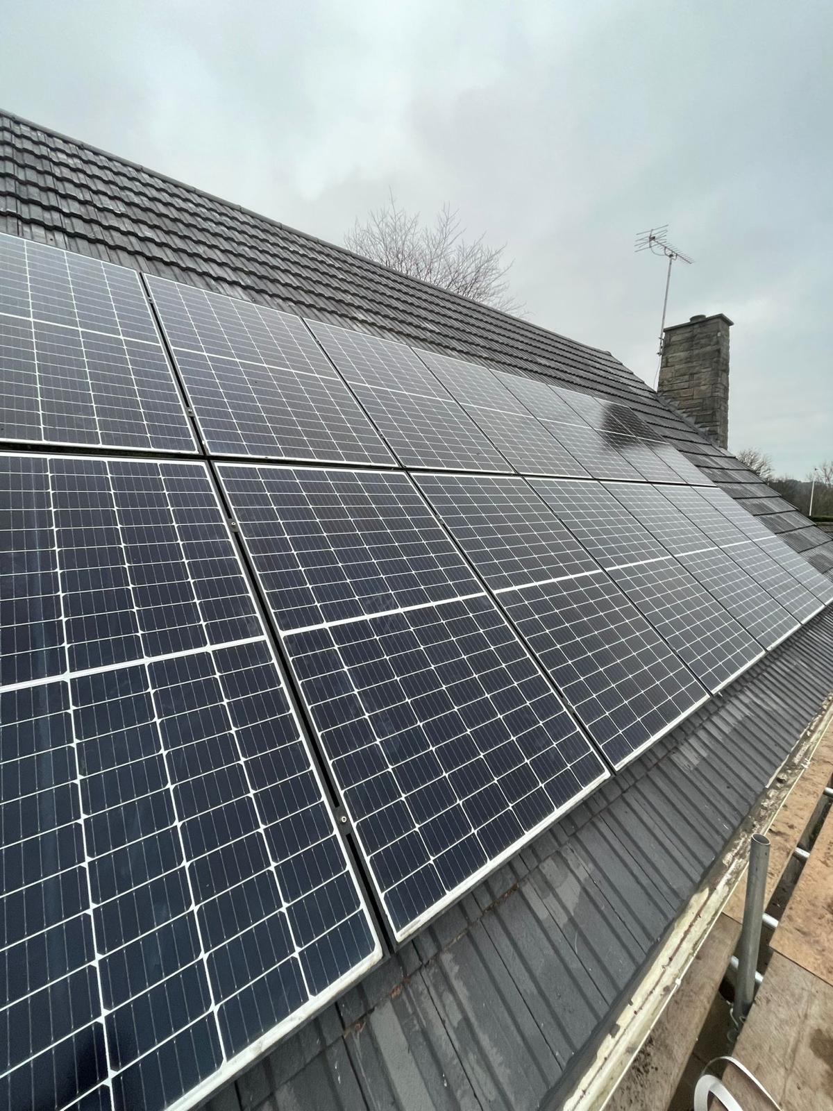 In-roof solar panel array on a black tile roof